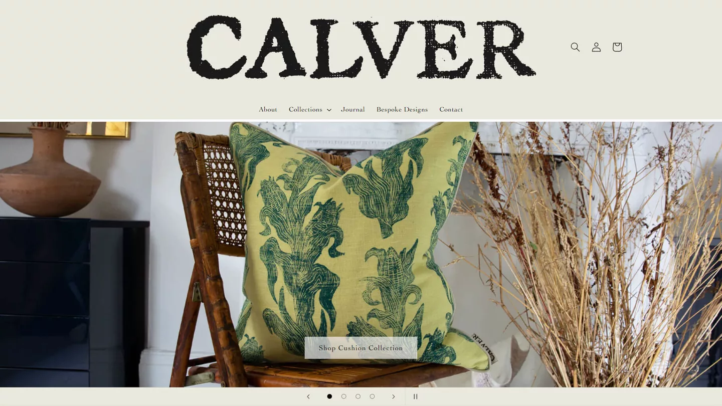 Calver homepage: a green corn-print cushion on a cane chair