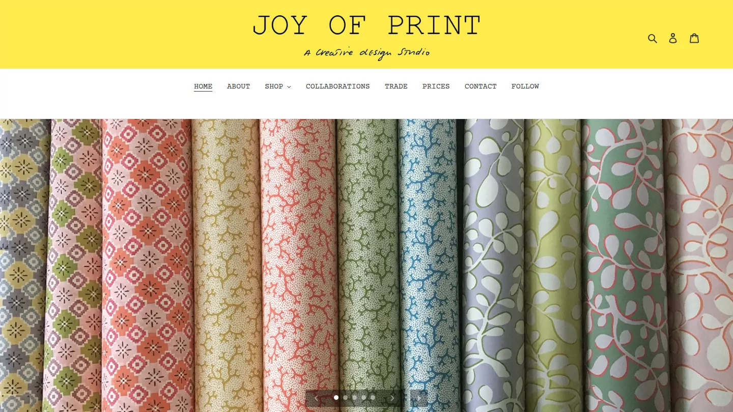 Joy of Print homepage: the yellow masthead above rolls of printed wallpaper